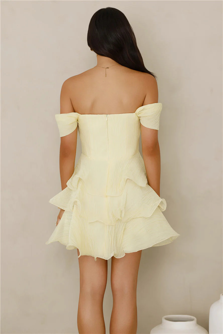 Back view of off-shoulder bow sleeve mini party dress with zipper closure, structured bodice, and tiered ruffle skirt